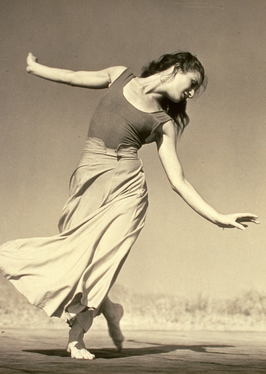 a photo of Bella as a young woman with long hair dancing outside